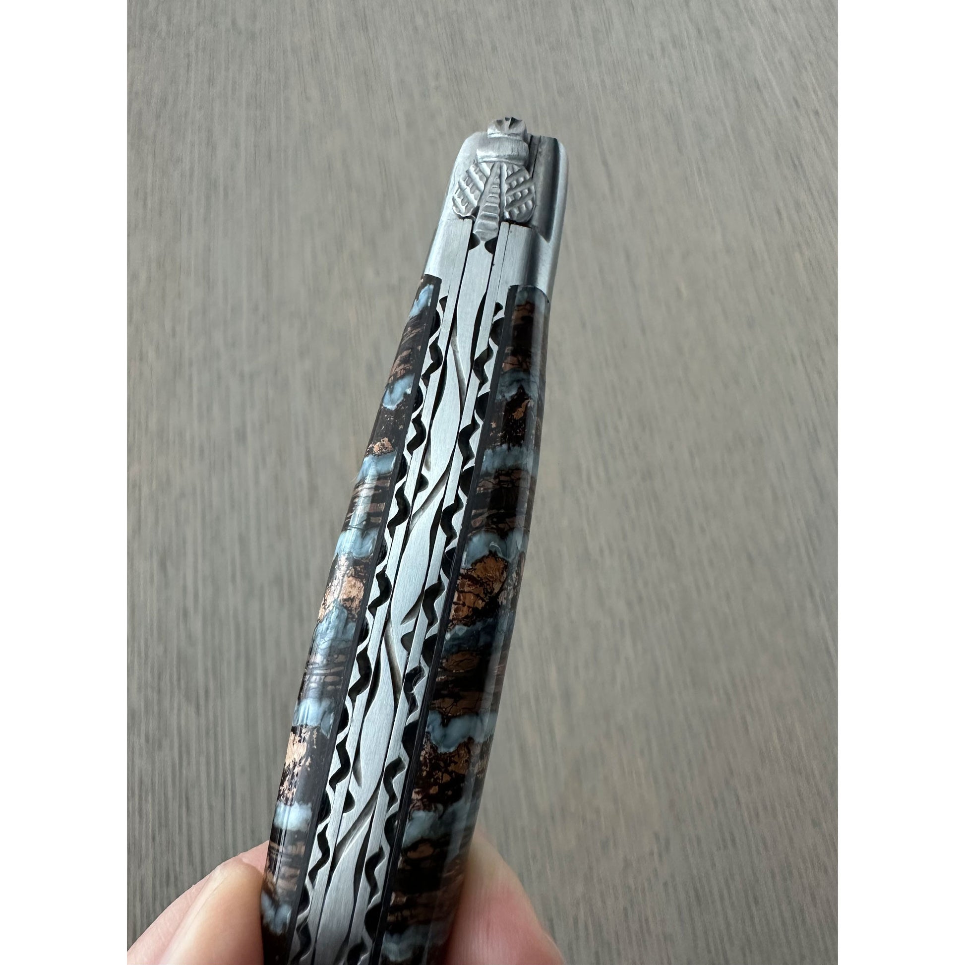 Forged bee and hand-filed spring detail on a Laguiole en Aubrac folding knife.