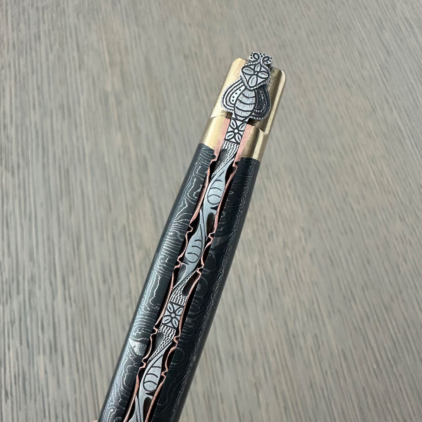 Close-up of hand-carved floral motifs on Laguiole en Aubrac knife handle