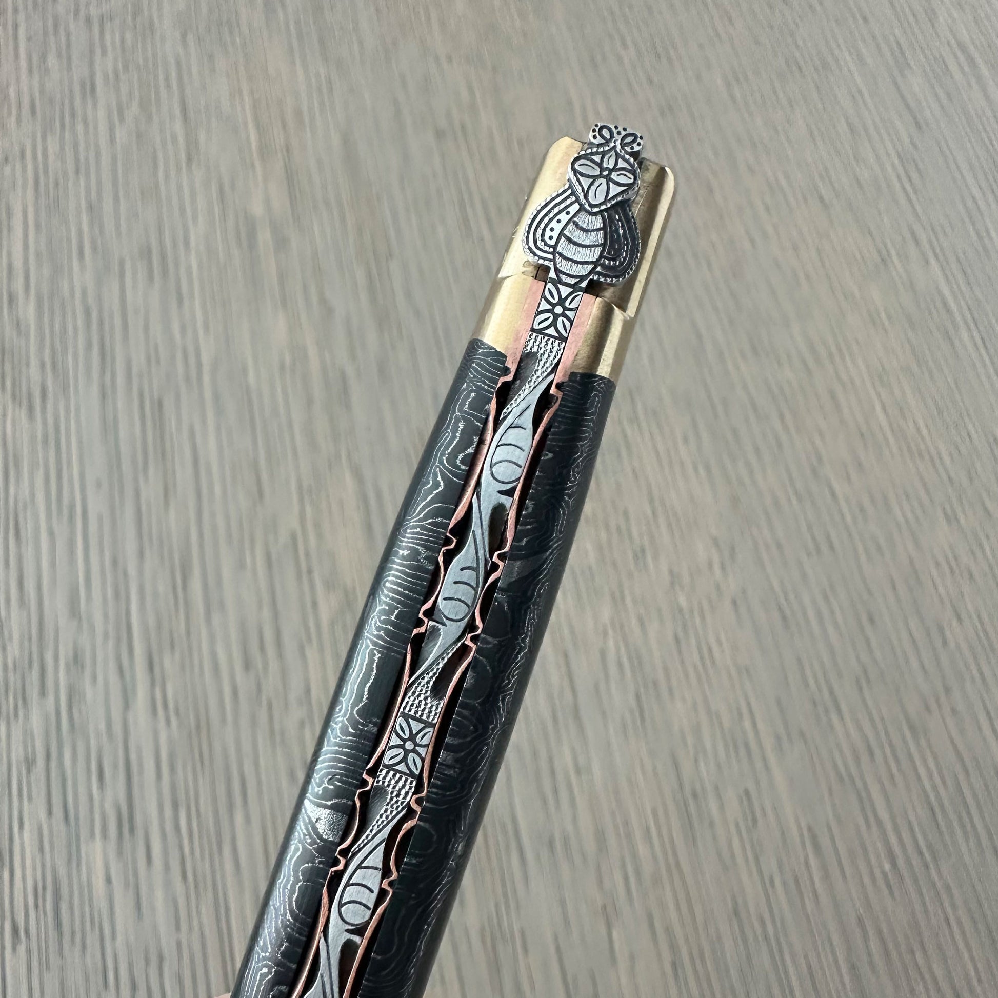 Close-up of hand-carved floral motifs on Laguiole en Aubrac knife handle