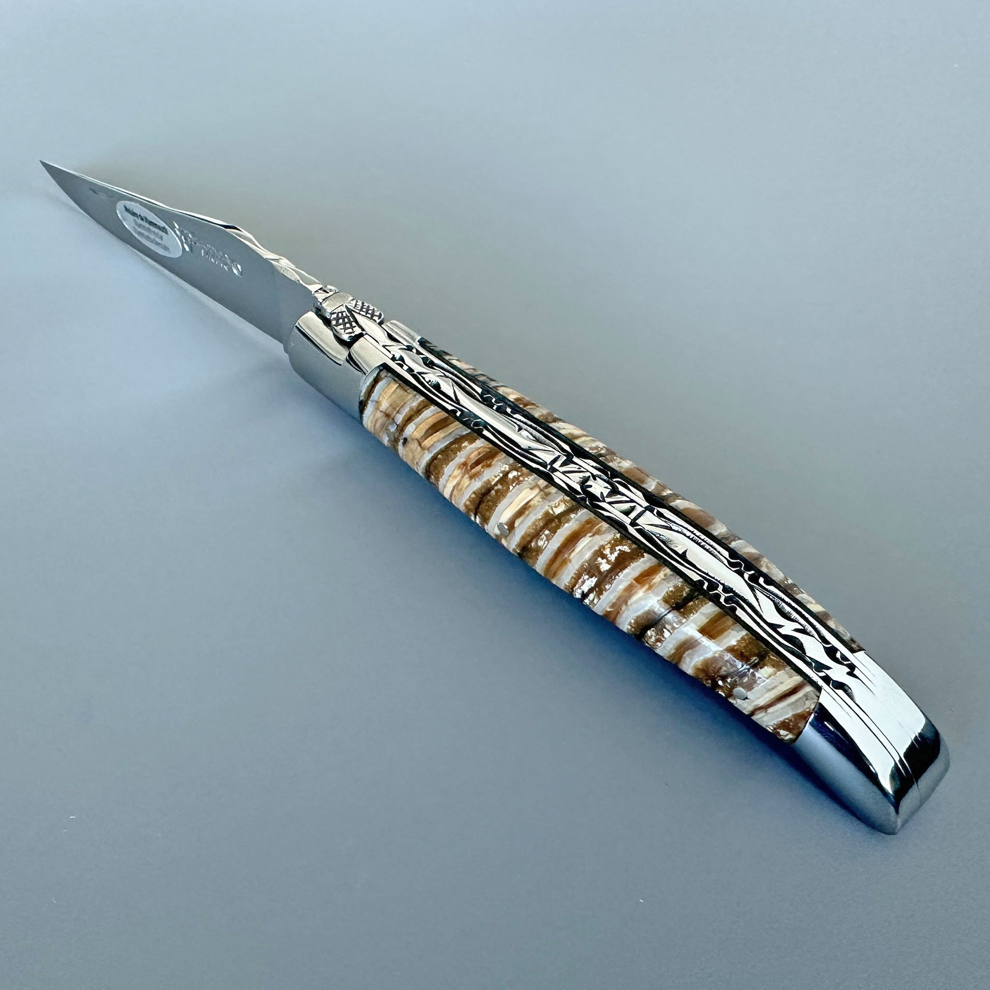 Open Laguiole en Aubrac double-plated folding knife with brown and beige mammoth molar handle