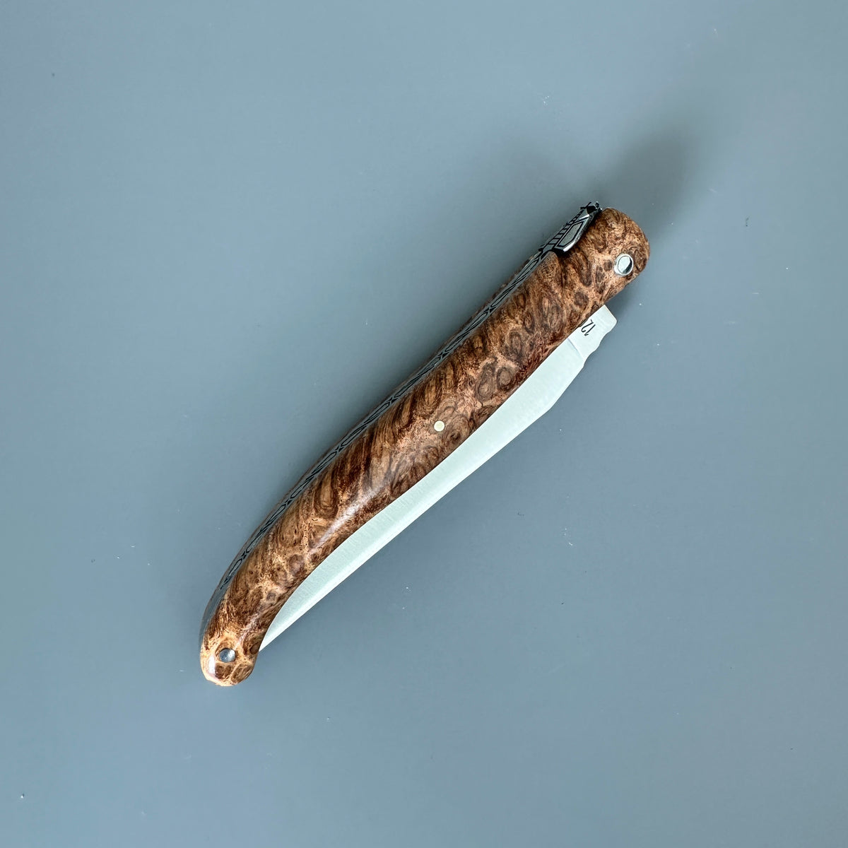 Reverse Laguiole en Aubrac folding knife with Amboyna burl wood handle in closed position