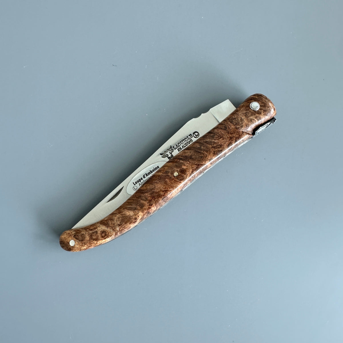 Closed Laguiole en Aubrac folding knife with Amboyna burl wood handle