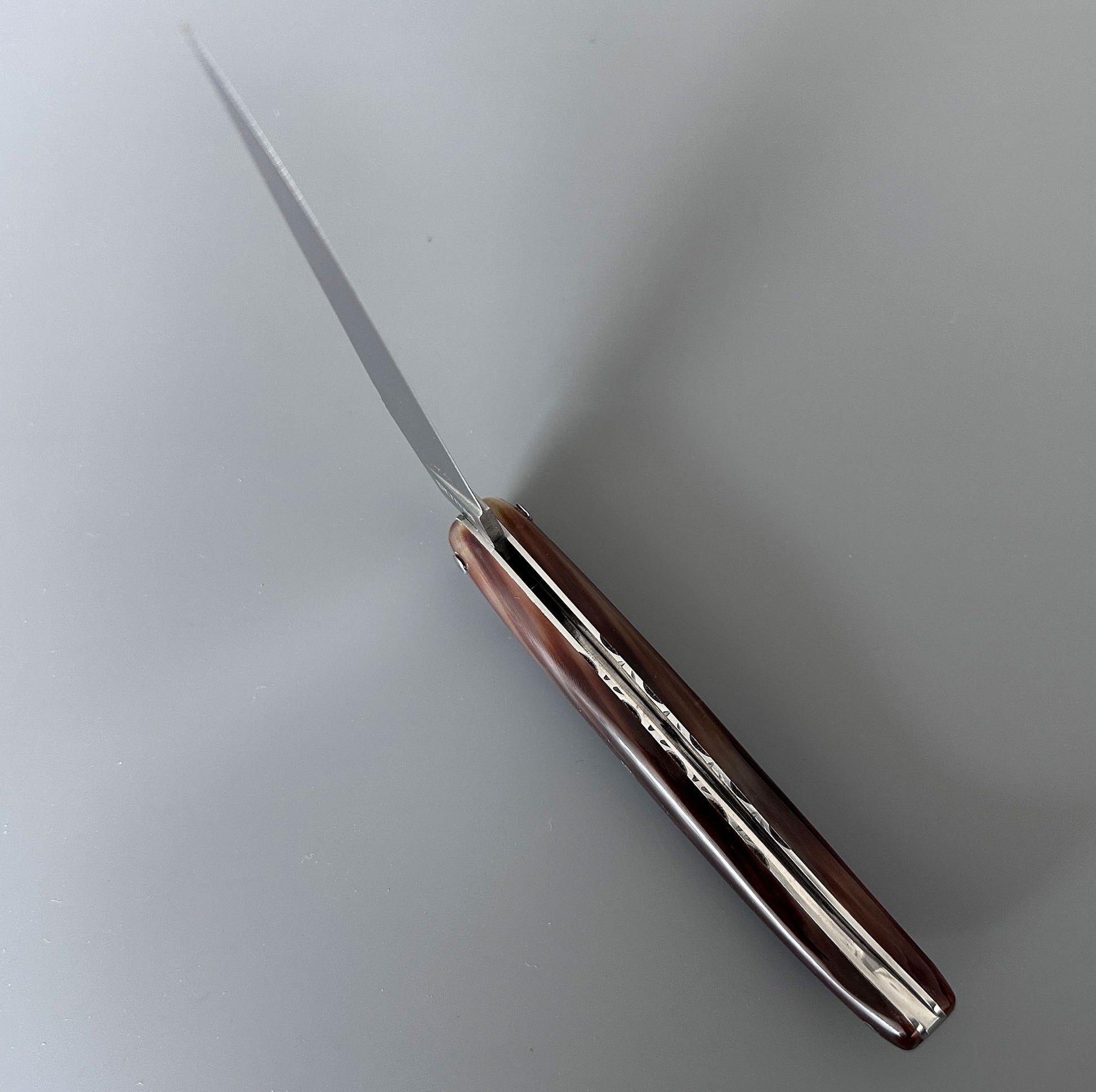 Inner Spine view of a Laguiole en Aubrac Origine Tour Eiffel knife showing its solid horn handle