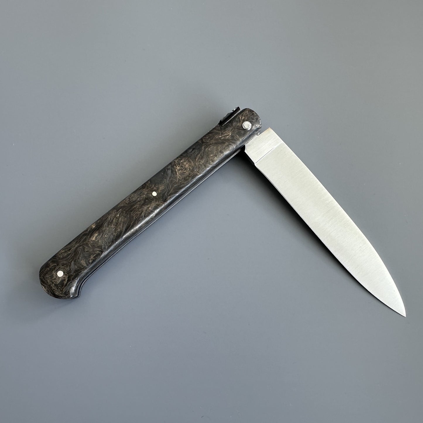 Laguiole Droit knife open and reversed, highlighting the straight blade profile and lockback mechanism at the spine