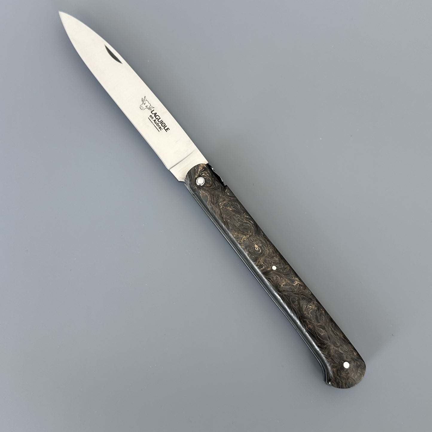 Laguiole Droit knife open, angled to show the full blade etched with the Laguiole en Aubrac bull logo