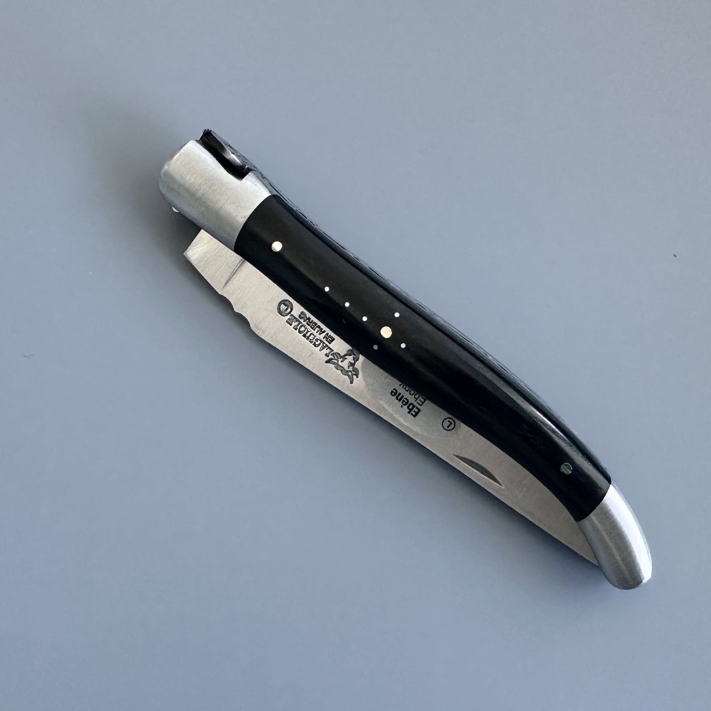 Laguiole en Aubrac knife closed, showing the blade etched with the Laguiole bull logo and "Ébène" ebony wood label