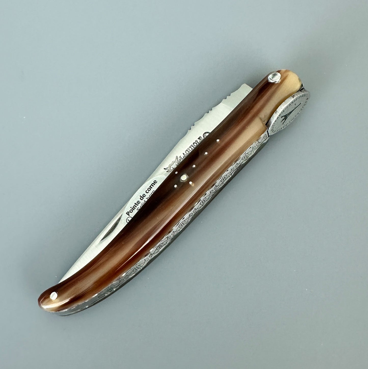Closed Laguiole en Aubrac Origine Tour Eiffel folding knife with solid horn handle and medallion