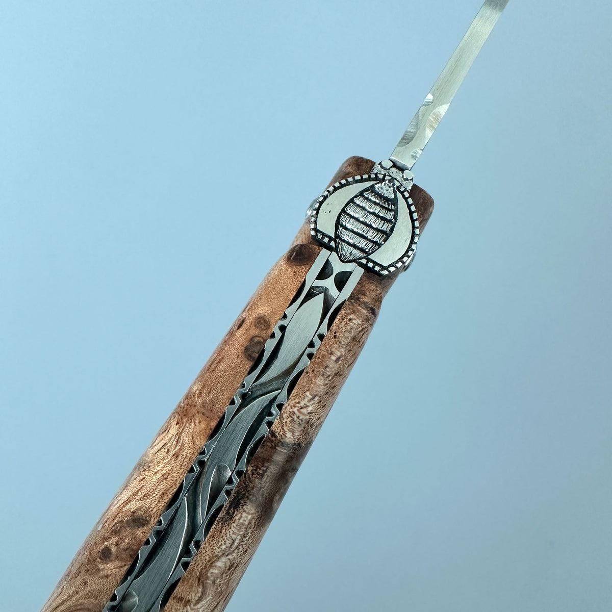 Laguiole en Aubrac close up of the bee folding knife with Albizia handle