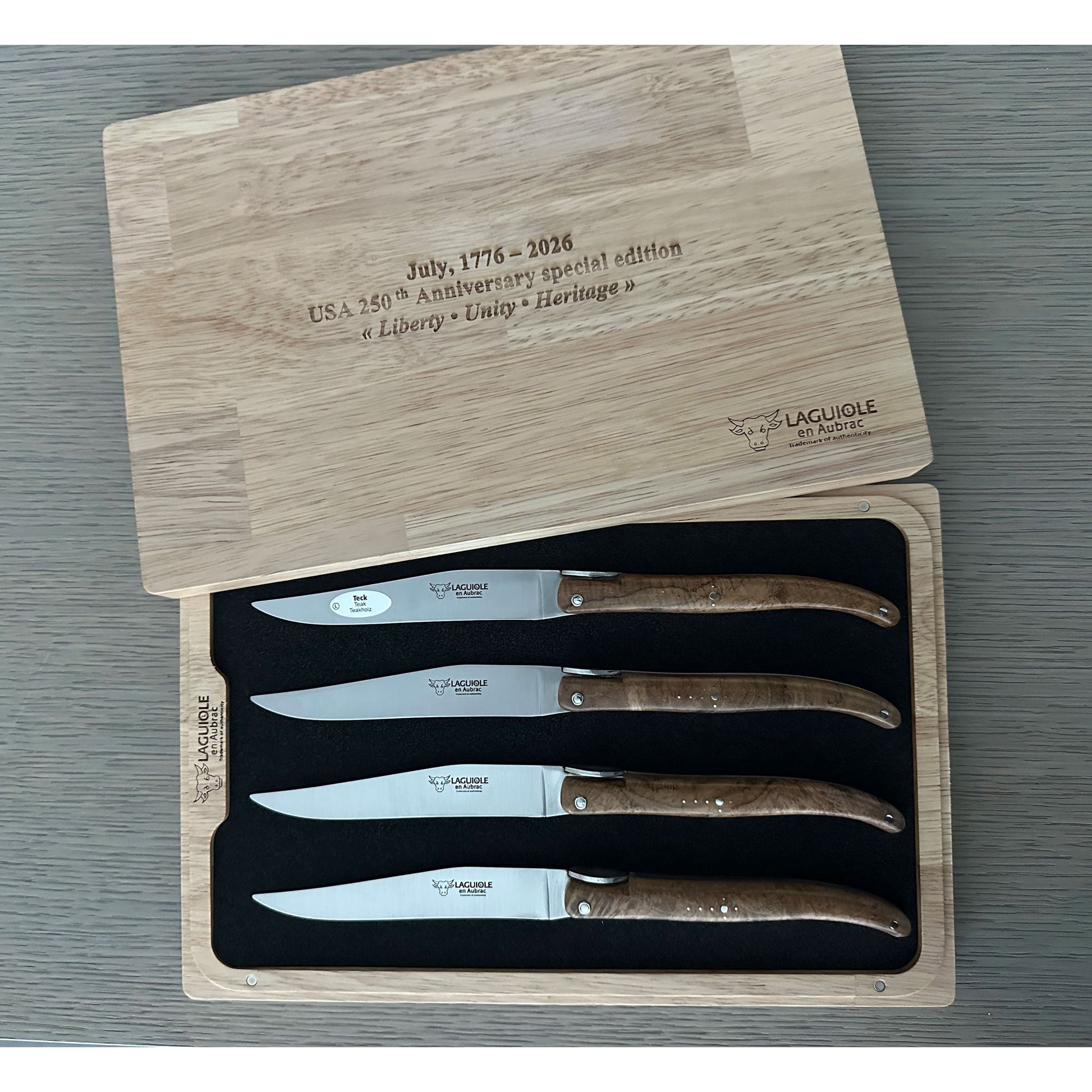 Set of four steak knives with wooden handles on branded wooden block