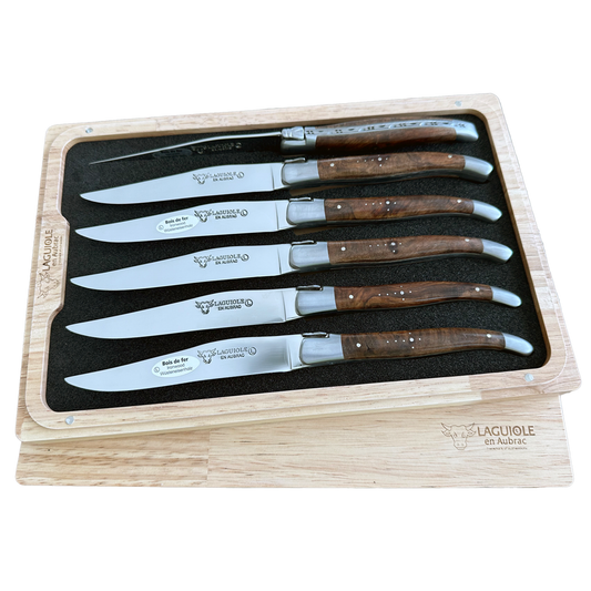 Set of six steak knives with wooden handles in a wooden box, featuring the Laguiole brand.