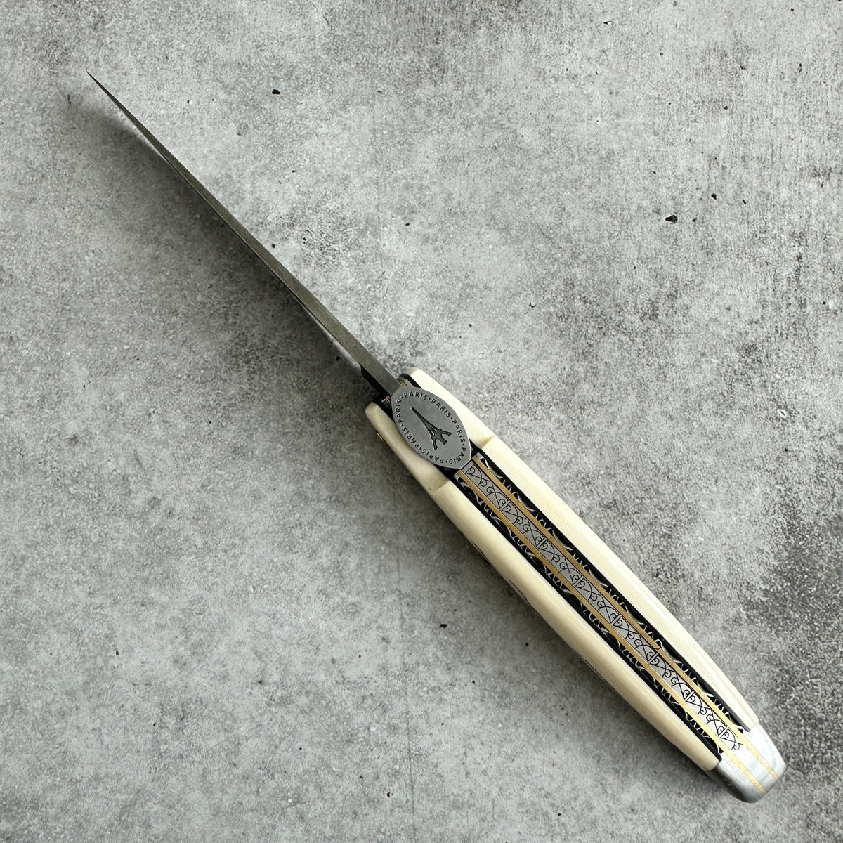Cenital view of Laguiole en Aubrac Eiffel Towel Folding knife Ivory Crust Handle