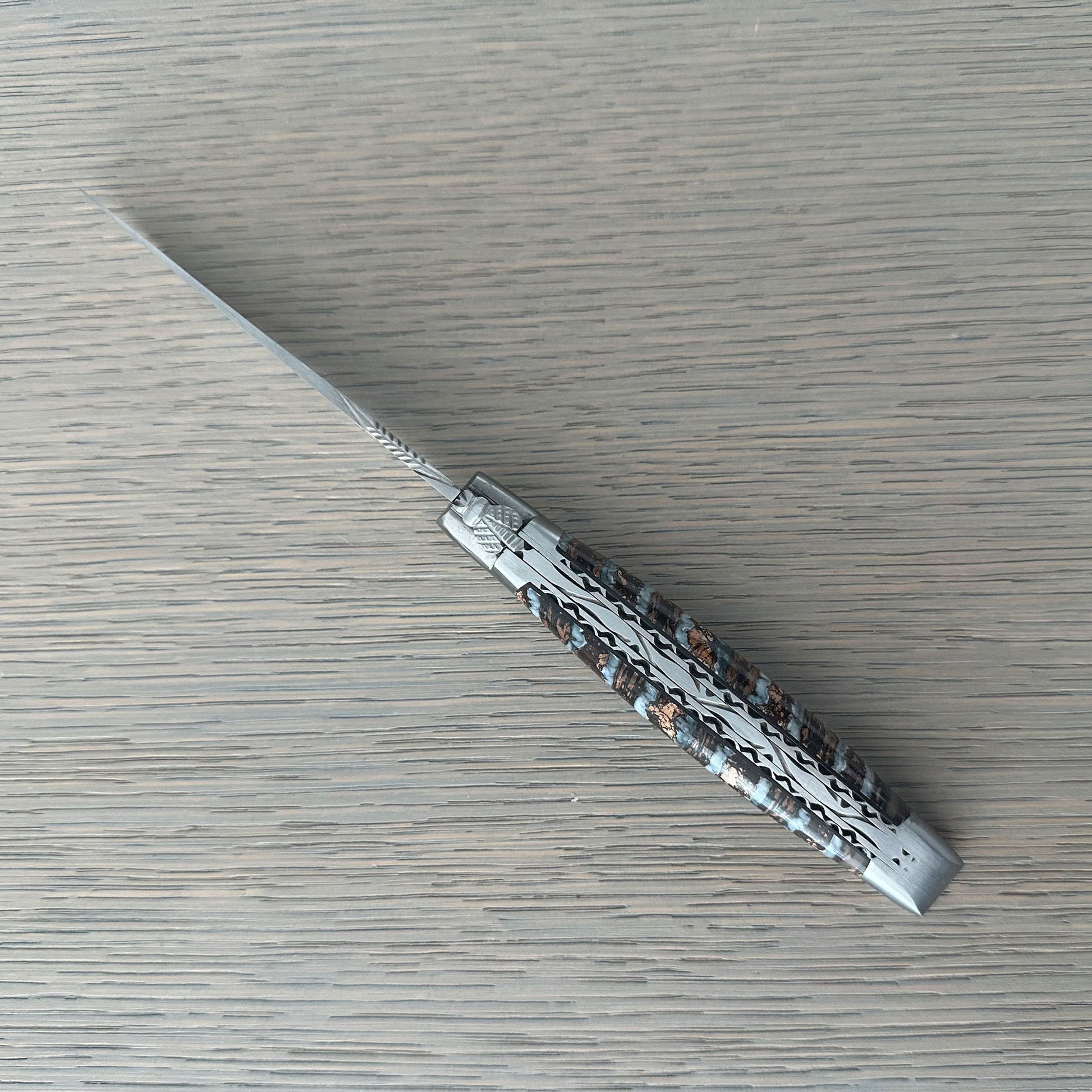 Open Laguiole en Aubrac Double-Plated folding knife with Light Brown Molar handle.