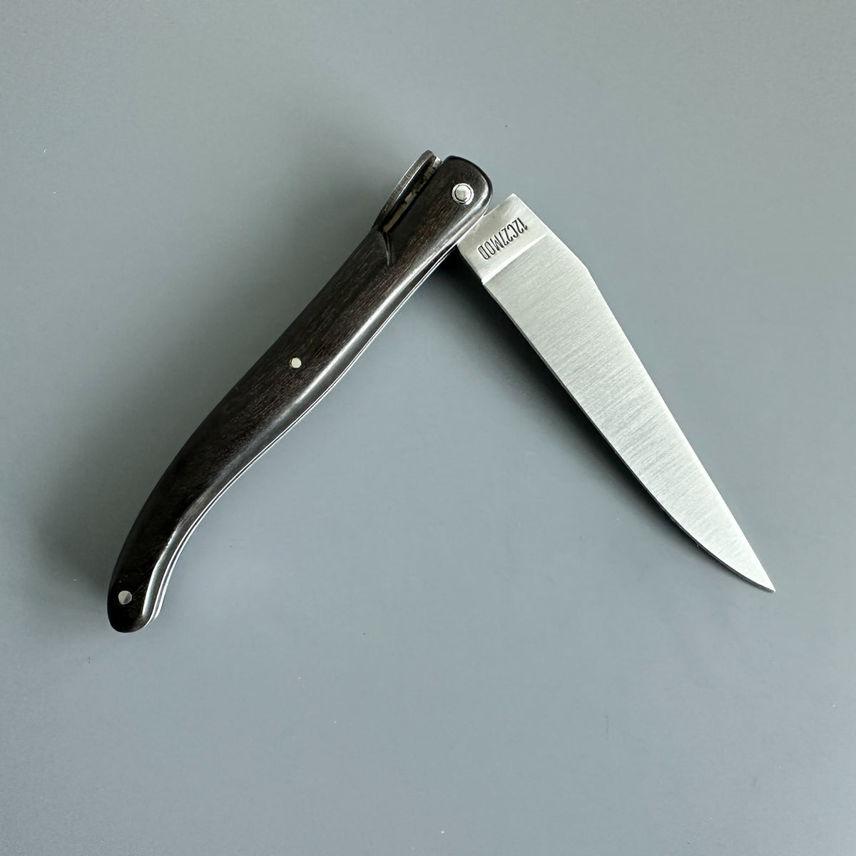 Reverse view of partially opened Laguiole en Aubrac USA Independence 250 anniversary folding pocket knife with Ebony Handle