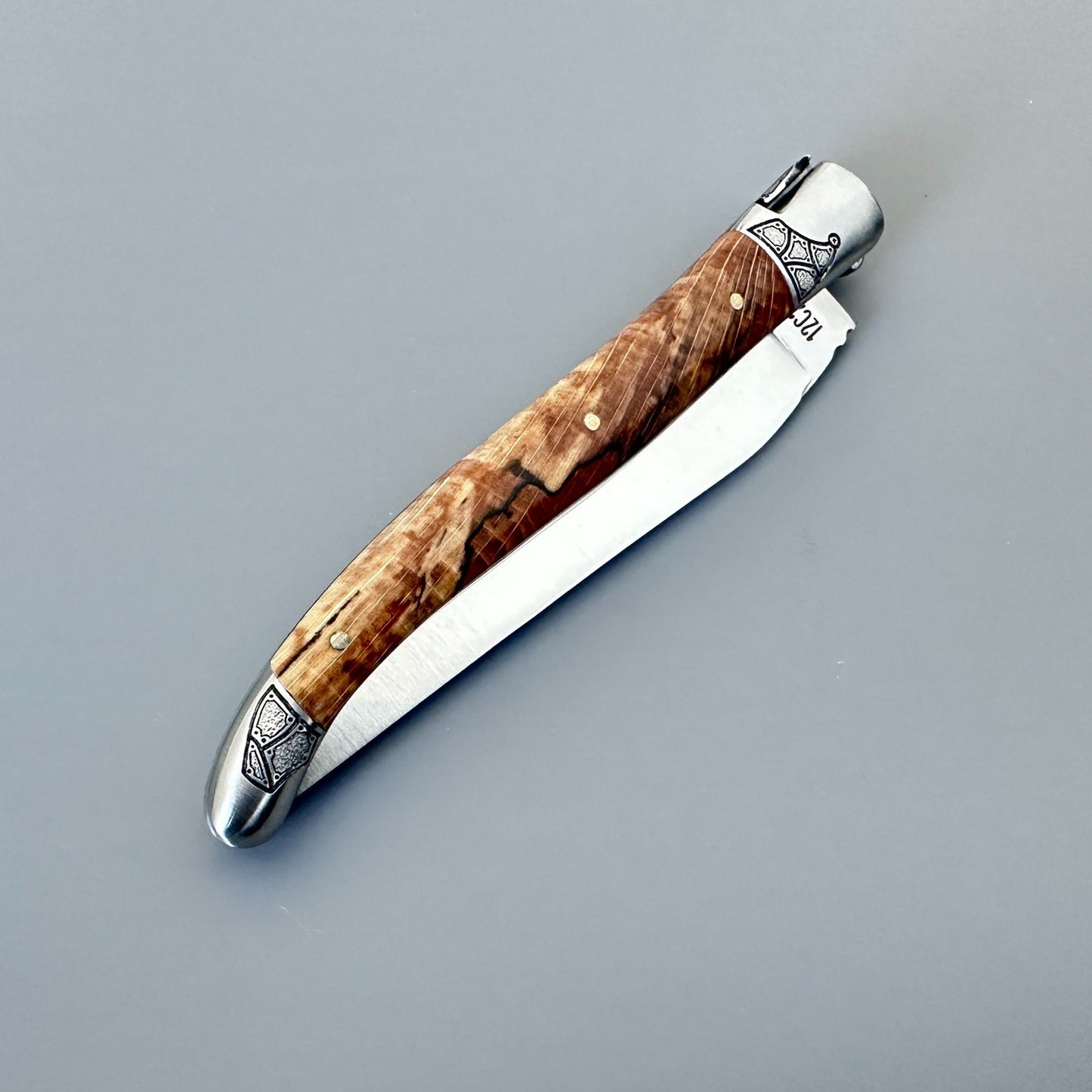 Reverse view of a closed Laguiole en Aubrac Belle knife with Aubrac wood handle