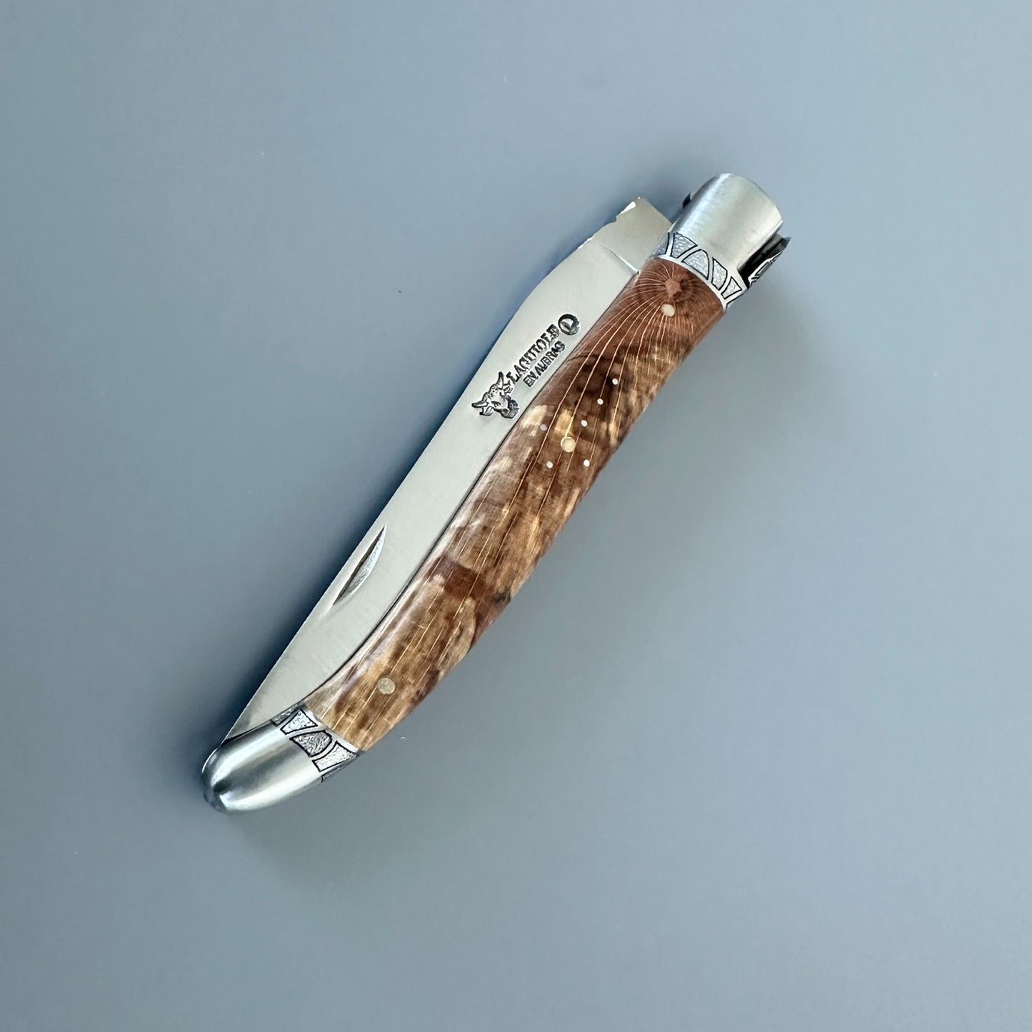 Closed Laguiole en Aubrac Belle knife with Aubrac wood handle, red inlay and engraved bolsters