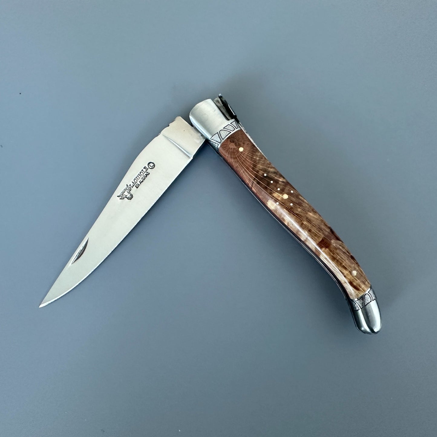 Open Laguiole en Aubrac Belle knife with Aubrac wood handle, red inlay and decorated bolsters