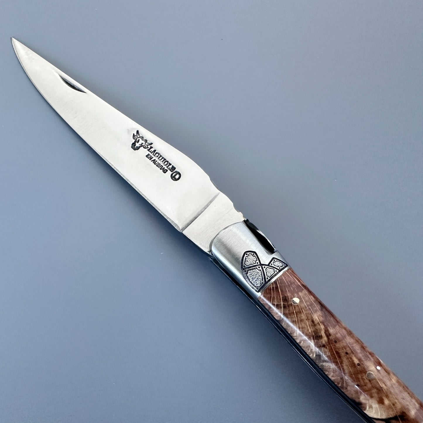 Close-up of a Laguiole en Aubrac Belle blade, special bee and guilloché bolster with black inlay