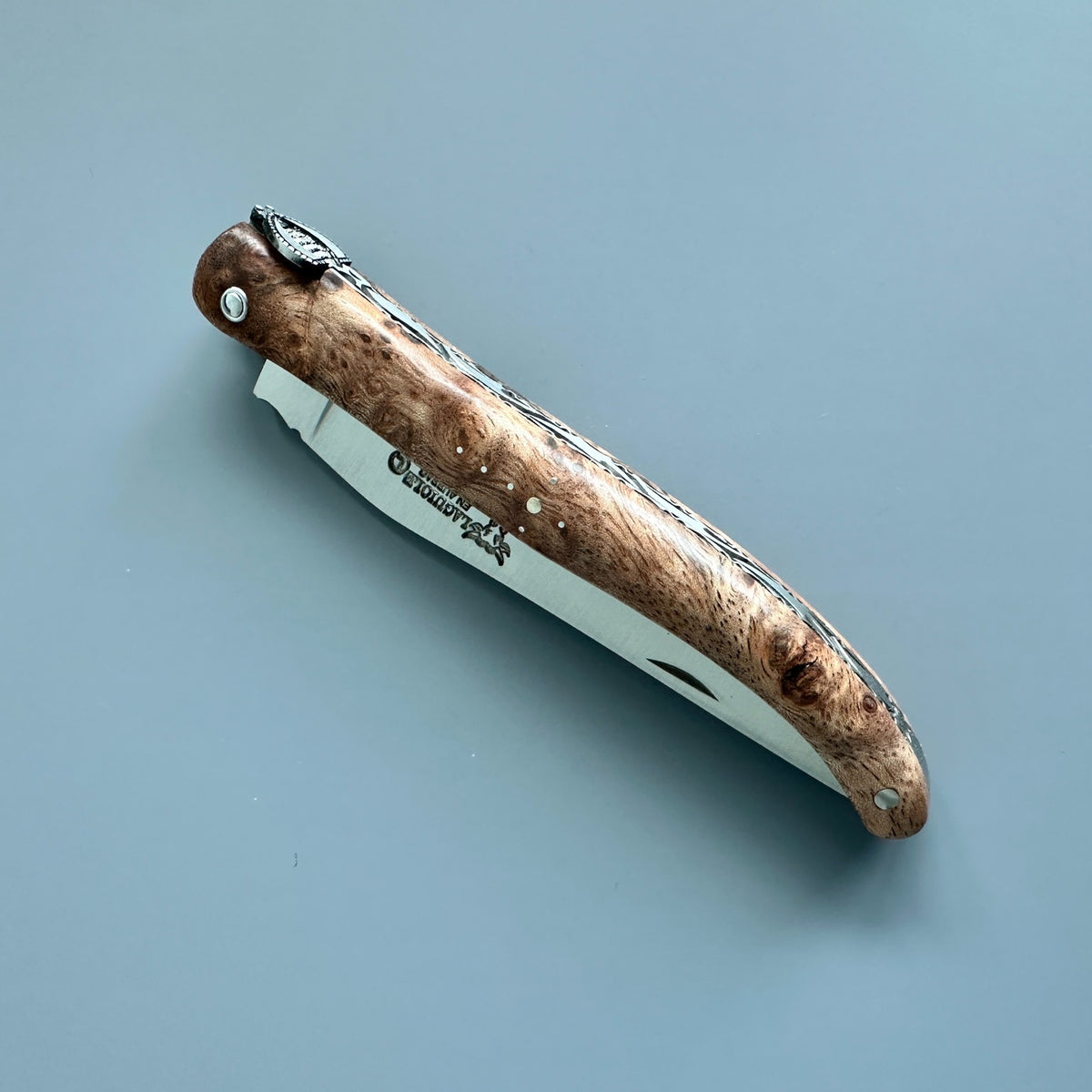 Lateral size of Laguiole en Aubrac partially open folding knife with Albizia handle