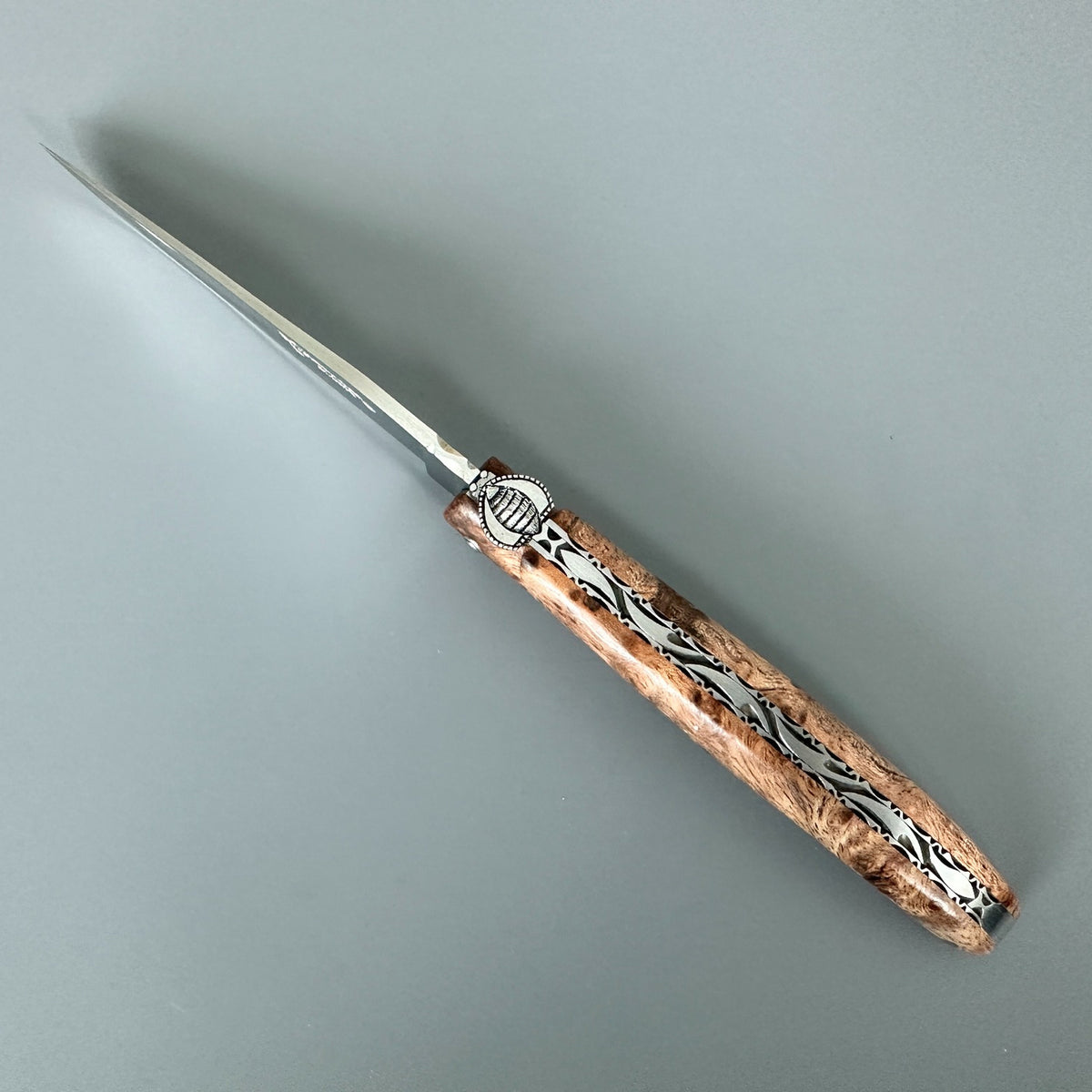 Laguiole en Aubrac Belle Piece Cenital view of open folding knife with Albizia wood handle