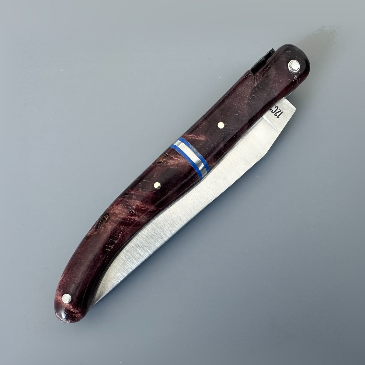 Laguiole en Aubrac reverse side of folding knife poplar wine burl handle