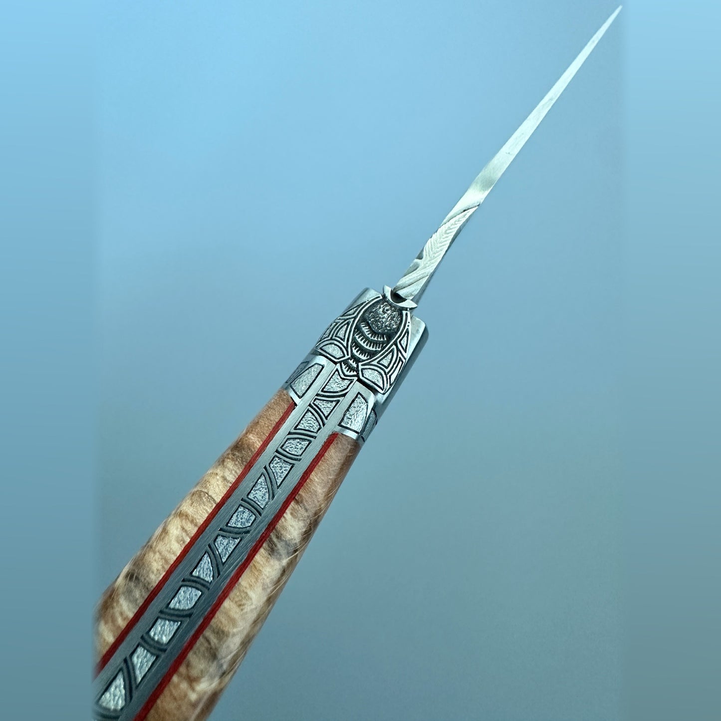 Closed Laguiole en Aubrac Belle knife with Aubrac wood handle, red inlay and engraved bolsters