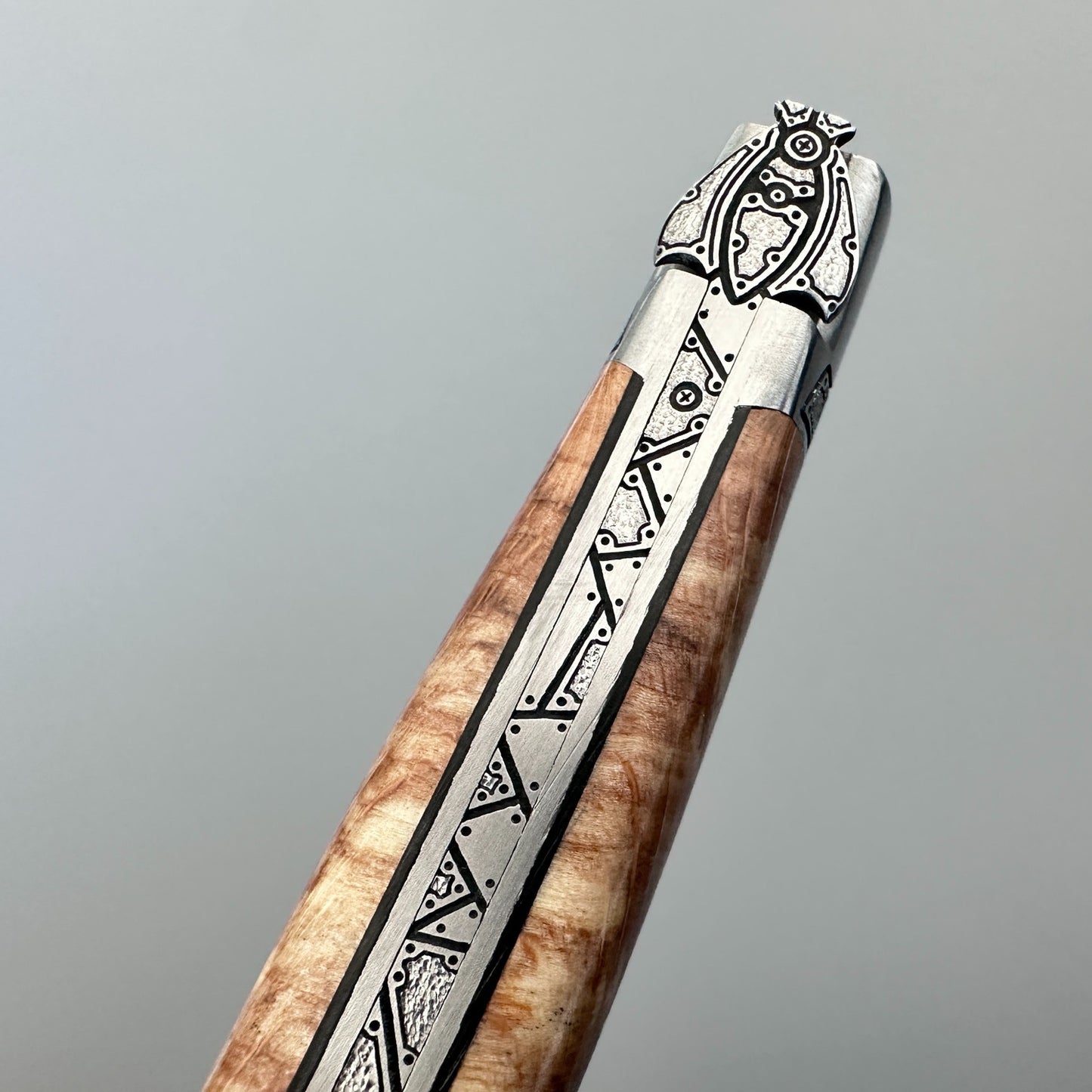 Closed Laguiole en Aubrac Belle knife with Aubrac wood handle, black inlay and guilloché bolsters