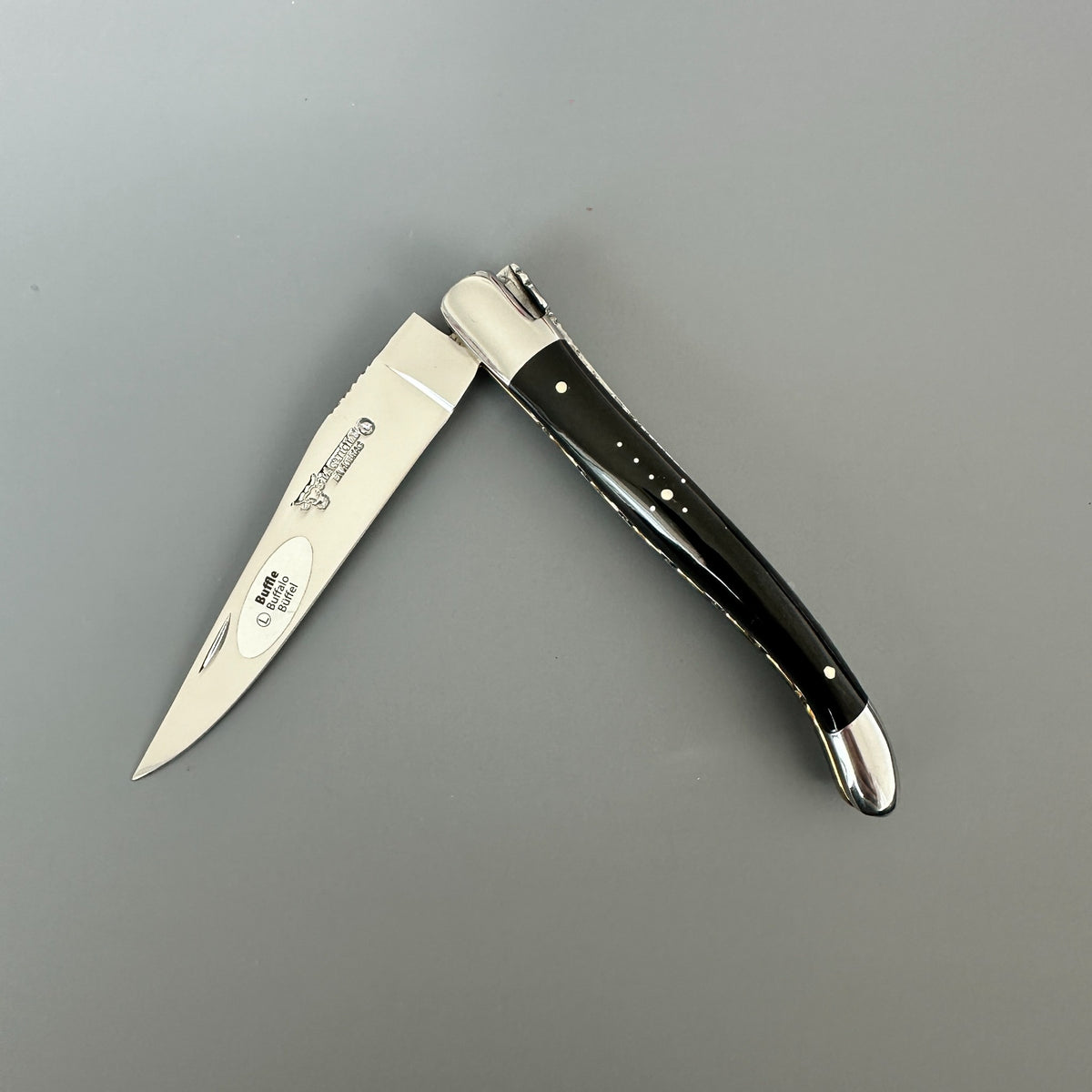 Laguiole en Aubrac double-plated pocket knife with a buffalo horn handle partially open