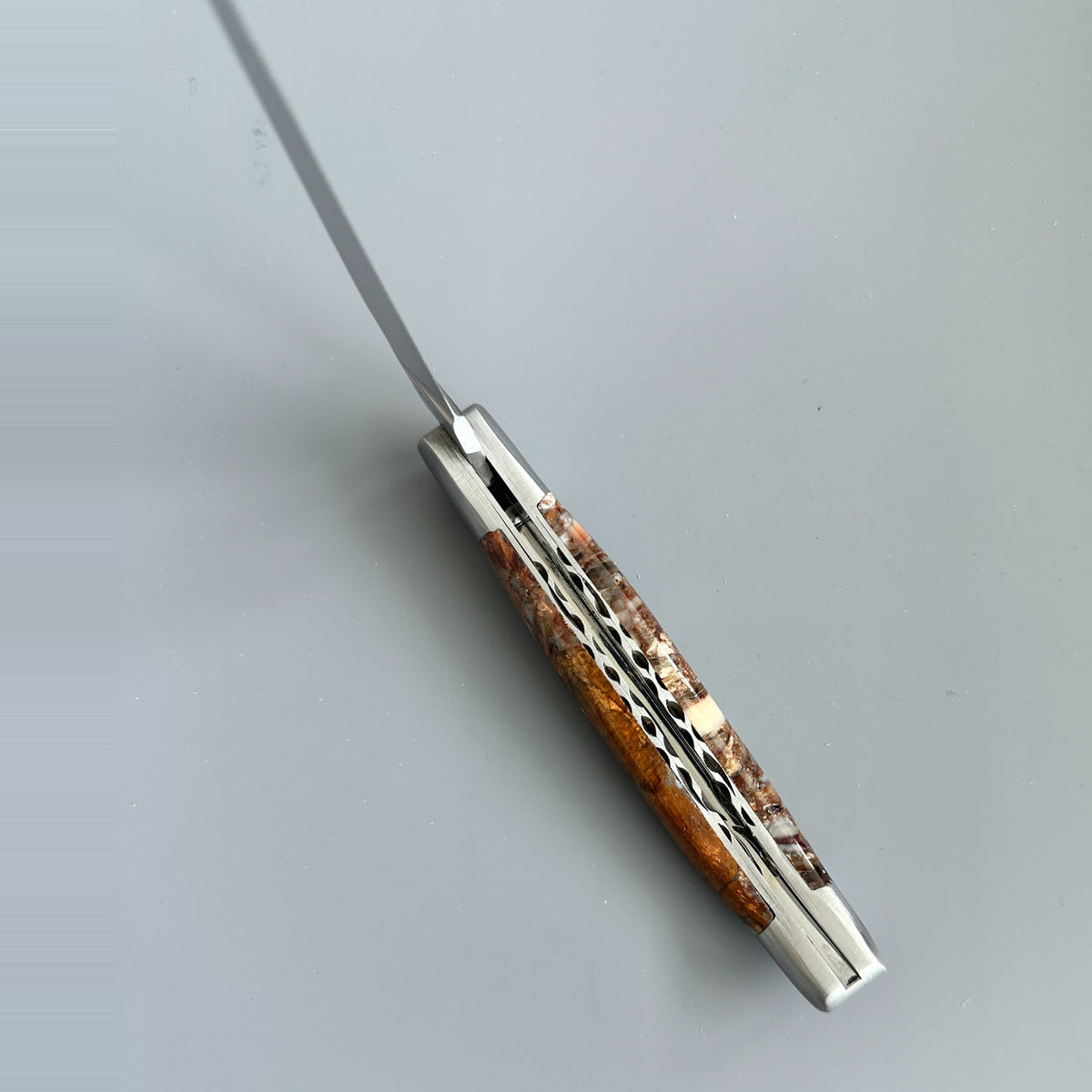 Inner spine of Laguiole en Aubrac Folding Knife with Brown Fusion Mammoth Ivory handle.