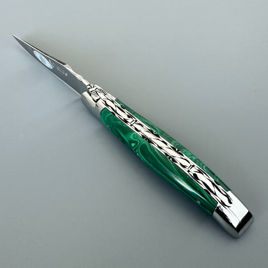 Angled spine view of a Laguiole en Aubrac double-plated knife with green malachite handle and file work