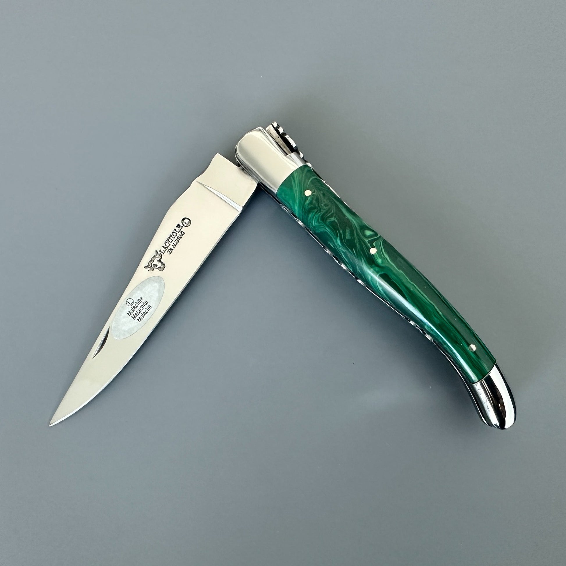 Open Laguiole en Aubrac double-plated folding knife with green malachite handle, front view