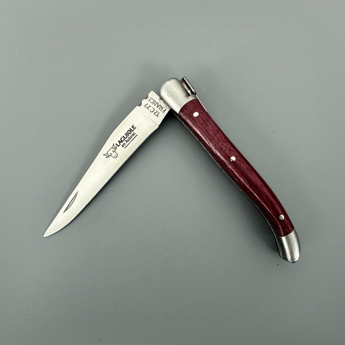 Open Laguiole en Aubrac Mini Folding Knife with an Amaranth wood handle and polished blade.