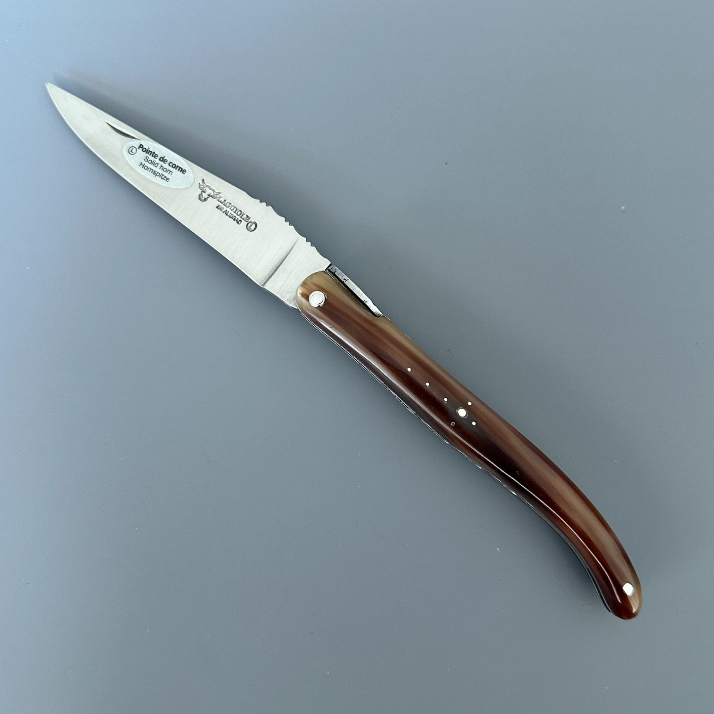 Fully open Laguiole en Aubrac Origine Tour Eiffel limited edition knife with solid horn handle