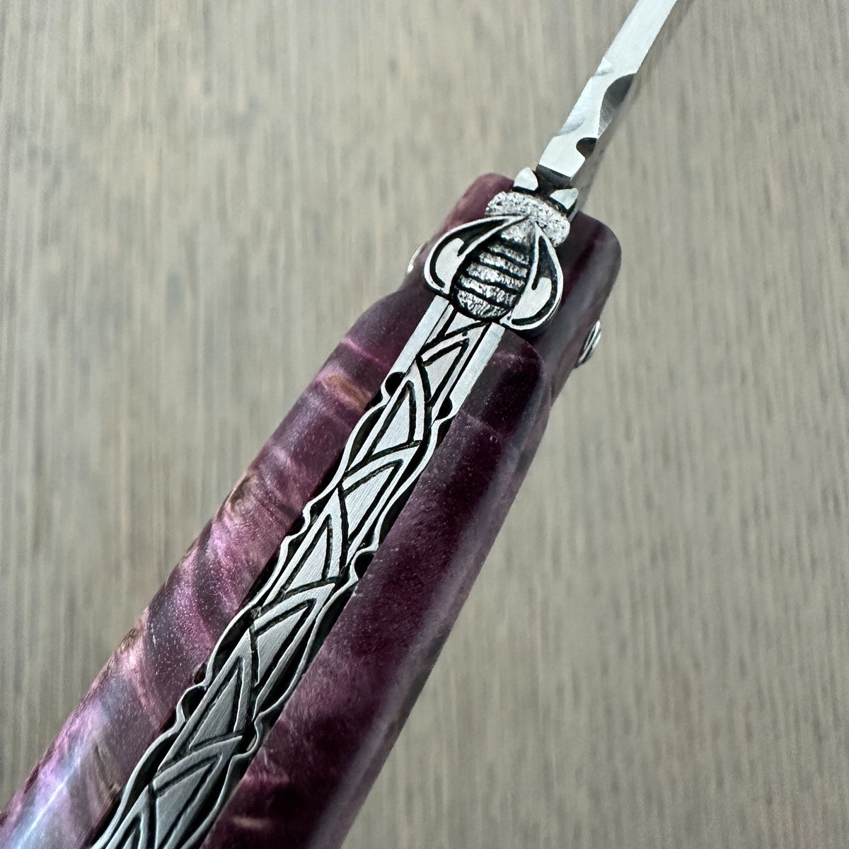 Close-up of the sculpted bee and intricate spine work on the Laguiole en Aubrac L0512WPH/FS-BP55 knife.